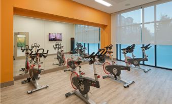 a well - equipped gym with numerous exercise bikes arranged in rows , creating a productive and healthy atmosphere at Even Hotel Rockville - Washington, DC Area, an IHG Hotel
