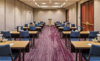a large conference room with rows of chairs arranged in a semicircle , providing seating for attendees at Courtyard Seattle Federal Way