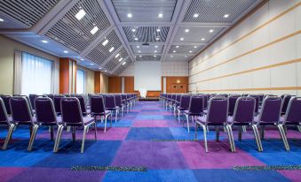 a large conference room with rows of chairs arranged in a semicircle , ready for a meeting at Radisson Blu Scandinavia Hotel, Aarhus