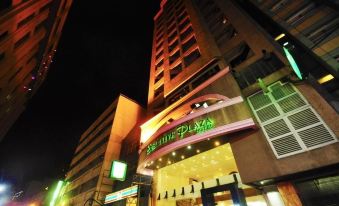 "a tall building with a green sign that reads "" shangri - la plaza "" on the side of the building" at Executive Hotel