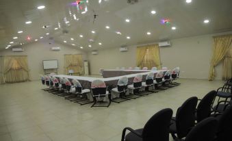a large conference room with multiple chairs arranged in a semicircle around a long table at Occasions