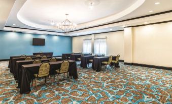 a large conference room with multiple tables and chairs , set up for a meeting or event at La Quinta Inn & Suites by Wyndham Dallas Grand Prairie South