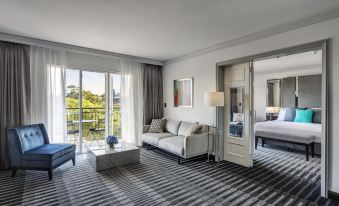 a spacious living room with a couch , a coffee table , and a window overlooking the city at InterContinental Sydney Double Bay, an IHG Hotel