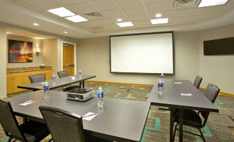 a conference room set up for a meeting , with several chairs arranged in rows and a projector mounted on the wall at Residence Inn Bridgewater Branchburg