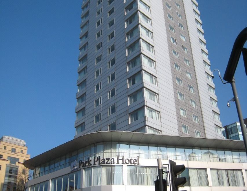 "a tall white building with the sign "" the plaza hotel "" in front of a clear blue sky" at Park Plaza Leeds