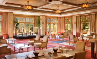 a spacious dining room with multiple chairs and tables , creating a warm and inviting atmosphere at CordeValle