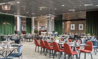 a large dining area with tables and chairs arranged for a group of people to enjoy a meal together at Radisson Blu Airport Hotel, Oslo Gardermoen