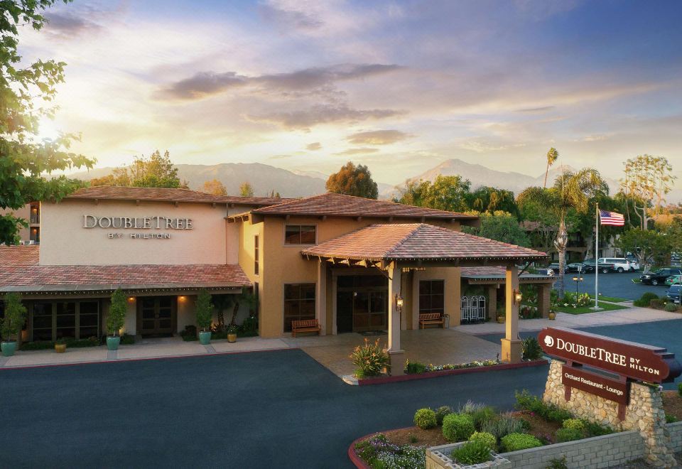 "a large building with a red tile roof and a sign that says "" el capitan ."" also several other buildings in the background" at DoubleTree by Hilton Claremont