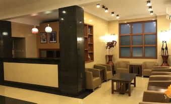 a modern hotel lobby with a reception desk , couches , and chairs arranged in a comfortable setting at Chelsea Hotel