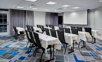 a large conference room with multiple rows of chairs arranged in a semicircle around a podium at Residence Inn Richmond Chester