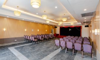 a large conference room with rows of chairs arranged in a semicircle , ready for a meeting or event at Livingston Hotel