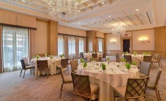 a large banquet hall with multiple tables set up for a formal event , possibly a wedding reception at The Townsend Hotel