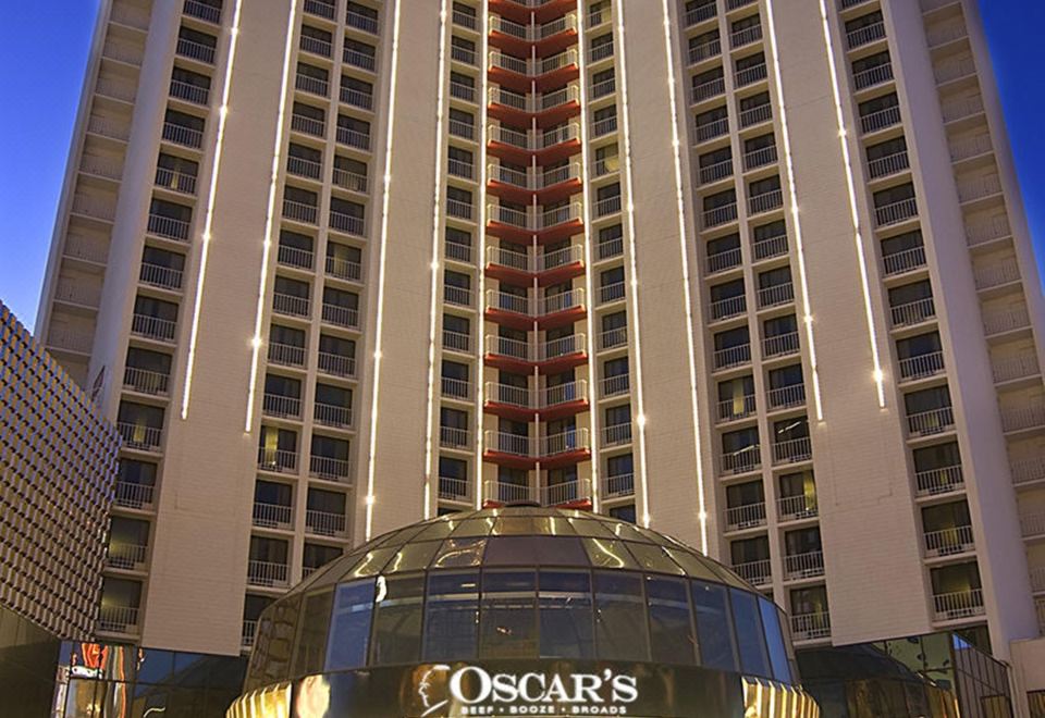 the hilton aria las vegas hotel , a large hotel with a dome and tower , illuminated at night at Plaza Hotel & Casino