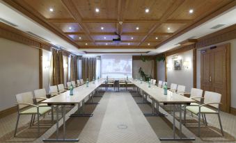 a conference room set up for a meeting , with chairs arranged in rows and a table in the center at Majestic Hotel & Spa Resort