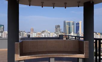 a rooftop with a view of a city skyline , including tall buildings and skyscrapers , as well as a bench overlooking the scene at Chelsea Hotel