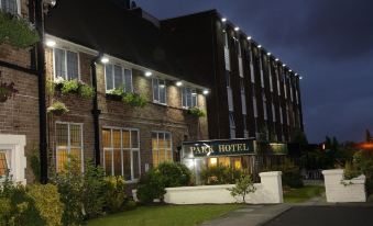 "a brick building with a sign that reads "" park hotel "" prominently displayed on the front" at The Park Hotel