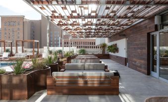 a rooftop area with several couches and chairs arranged in rows , providing seating for guests at Hotel Indigo El Paso Downtown