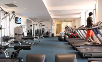 a well - equipped gym with a variety of exercise equipment , including treadmills , stationary bikes , and weight machines at Radisson Blu Hotel, Bamako