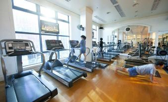 In the large room, there are people using treadmills in the gym at Hanoi Daewoo Hotel