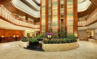 The hotel lobby features a spacious staircase and potted plants in every room on both floors at Aryaduta Bandung