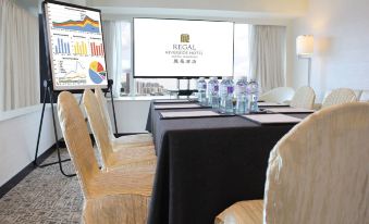 There is a meeting room arranged with tables and chairs for hosting events or social functions at Regal Riverside Hotel