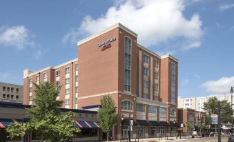 "a large brick building with a sign that says "" university of connecticut "" on it , located in a city street" at TownePlace Suites by Marriott Champaign