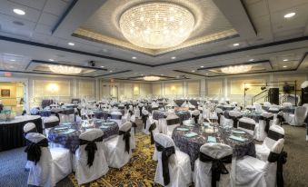 a large banquet hall with numerous tables and chairs set up for a formal event , possibly a wedding reception at The Inn at Wise