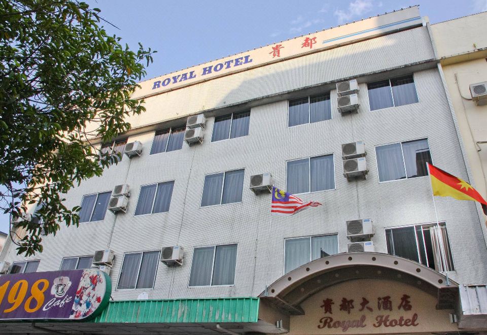 the exterior of the royal hotel , a white building with american flag flying from the top at Royal Hotel