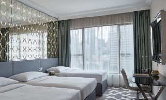 a hotel room with three beds , two of which are twin beds and one is a double bed at Dorsett Wanchai