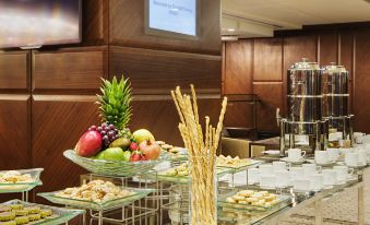 a buffet table with various types of food , including fruits and snacks , set up for an event at DoubleTree by Hilton Istanbul-Avcilar