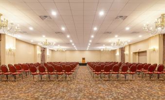 The ballroom is a spacious venue equipped with rows of chairs, ideal for hosting events or conferences at Hotel Pennsylvania