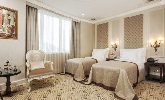 a hotel room with two beds , one on the left and one on the right side of the room at DoubleTree by Hilton Gaziantep