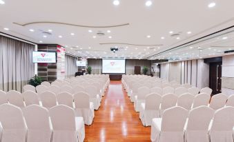 A spacious event room is arranged with rows of chairs facing the front at a hotel at The Salisbury YMCA of Hong Kong
