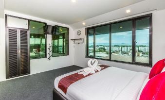 a bedroom with a large window and a bed featuring a swan decoration and a cityscape view at Soho Boutique Hotel