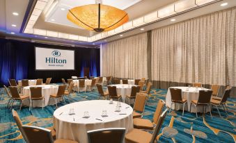 a large conference room with tables and chairs set up for a meeting or event at Hilton Miami Airport Blue Lagoon