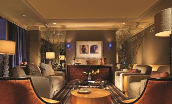 a modern living room with two couches , a coffee table , and framed art on the walls at Fairmont Dallas