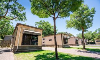 a row of modern houses with trees and a clear blue sky in the background at Adelaide Caravan Park - Aspen Holiday Parks