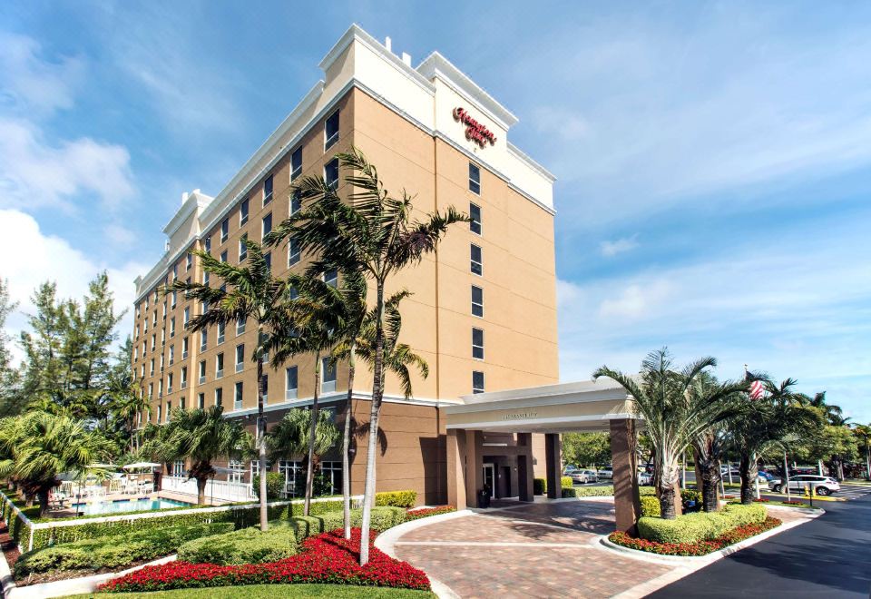 "a large , modern hotel building with a red roof and the name "" hampton inn "" on top" at Hampton Inn Hallandale Beach-Aventura