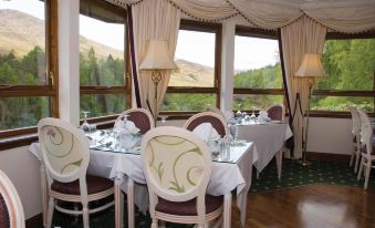 a dining room with tables and chairs arranged for a group of people to enjoy a meal together at Glenspean Lodge Hotel