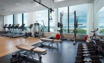 a well - equipped gym with a variety of exercise equipment , including treadmills , weight machines , and benches at Gothia Towers & Upper House