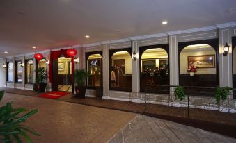 a hotel entrance with a red carpet leading up to the second floor , which is decorated with potted plants and a sign indicating the location at Kimberley Hotel Georgetown