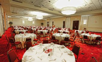a large dining room with many round tables and chairs , all set for a formal event at Mobile Marriott