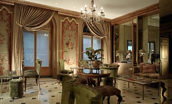 a well - decorated living room with elegant furniture , including a couch , chairs , and a dining table at Hotel d'Angleterre