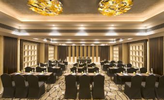 a large conference room with multiple tables and chairs arranged for a meeting or event at Radisson Blu Gorakhpur