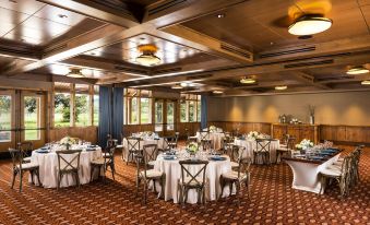 a large dining room with several round tables and chairs arranged for a formal event at Sunriver Resort