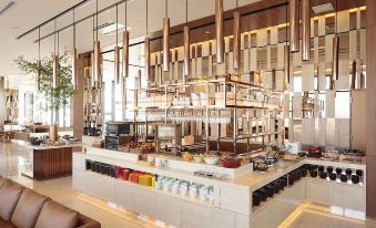 a large , modern restaurant with a bar and dining area , where people are enjoying their meals at Candeo Hotels Omiya