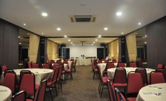 a large conference room with tables and chairs arranged for a meeting or event , surrounded by white curtains at Kimberley Hotel Georgetown