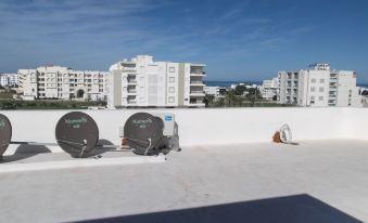 a rooftop with two satellite dishes , one on the left side and the other on the right side of the frame at Rahma