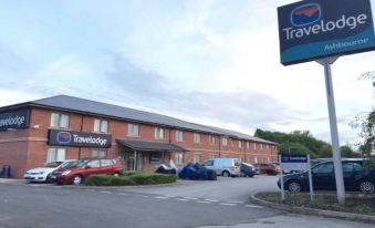 "a large red brick building with a sign that reads "" travelodge "" prominently displayed on the front of the building" at Travelodge Ashbourne