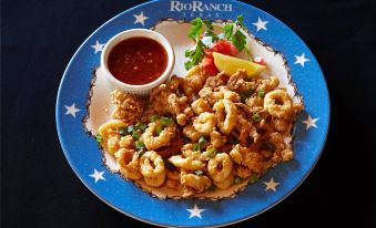 a plate of food with a blue border and an image of shrimp on it at Hilton Houston Westchase